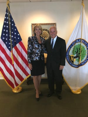 Ave Maria President Jim Towey stands with Education Secretary Betsy DeVos in Washington, D.C., on April 3, 2018. Towey’s invitation to DeVos to speak at the university’s graduation in May has elicited opposition from Ave Maria alumni.