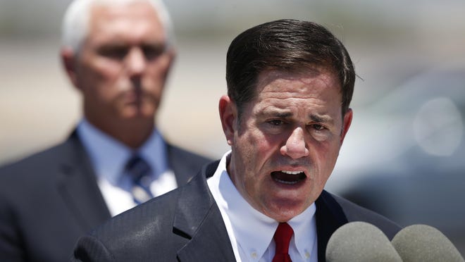 Similar to Florida Gov. Ron DeSantis, Arizona's Gov. Doug Ducey, pictured, downplayed the risks and took a non-aggressive approach, his critics say. Months later, the state is among the world's worst coronavirus hotspots.