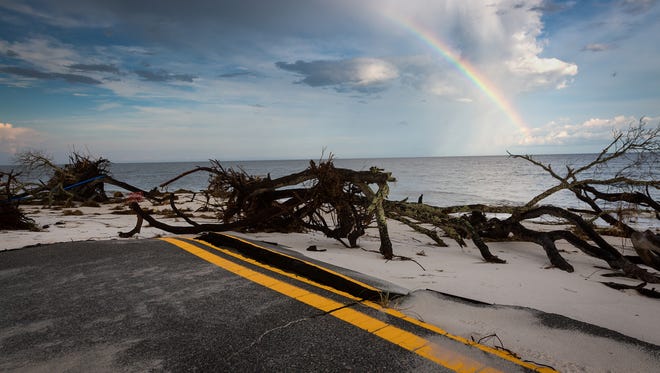 The evening after Hurricane Hermine made landfall nearby, debris covers the end of Gulfshore Boulevard in Alligator Point, Fla. on Sept. 2, 2016. The stretch of road in the rural Florida Panhandle beach community is eroding into the Gulf of Mexico as infrastructure and homes are damaged and destroyed as the problem worsens.