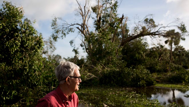 Jerry Hunt assesses damage to his four-acre property along Price Street in East Naples a day after Hurricane Irma made landfall in Southwest Florida Monday, September 11, 2017.
