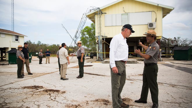 United States Secretary of the Interior Ryan Zinke talks with Pedro Ramos, Superintendent for Everglades & Dry Tortugas National Parks, as he surveys the damage to the Gulf Coast Visitor Center in Everglades National Park on Friday, October 6, 2017.