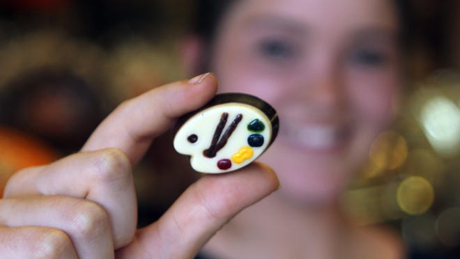 Missouri visitor Maggie Munsterman displays one of the fine truffles on offer at Dolce Mare Chocolate Boutique and Lounge.