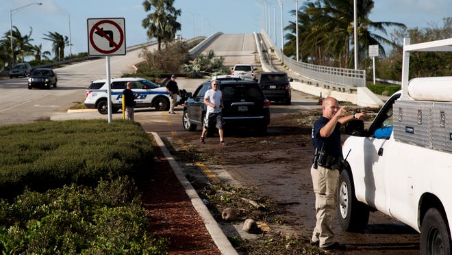 Marco Island Police turn away residents from crossing the Jolley Bridge on the northern side of Marco Island, Fla. a day after Hurricane Irma had passed through Monday, September 11, 2017. Police cited damage assessment and downed power lines as the reason for turning away people away.