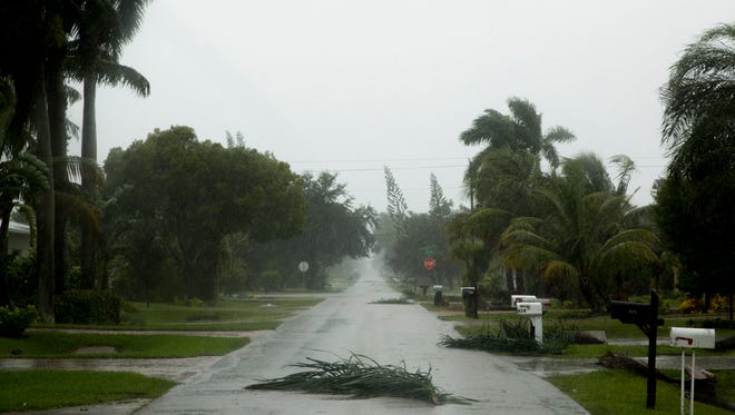 Downed power lines, felled trees, branches, and other debris litter Naples, Fla. and Bonita Springs, Fla. as Southwest Florida prepares for Hurricane Irma to make landfall midday Sunday, September 10, 2017.