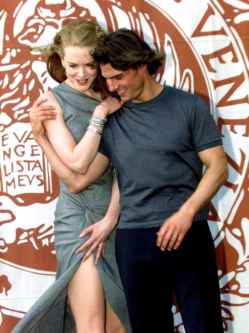 Tom Cruise and his then wife, Nicole Kidman, pose for photographers during a photocall for the 56th Venice Film Festival.