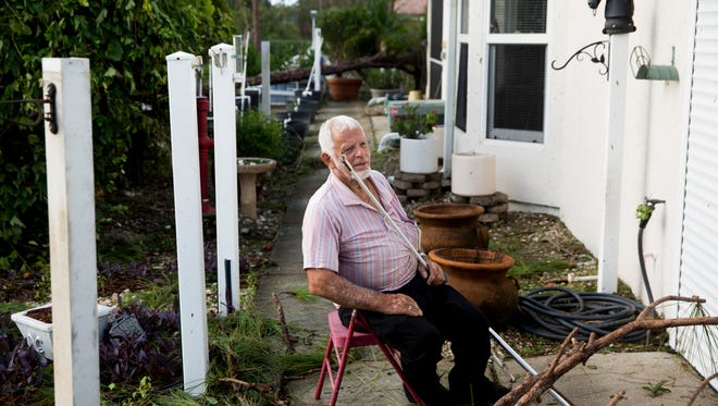 Rolan Vermette, 81, takes a moment to sit outside of his home and relax along Price Street in East Naples a day after Hurricane Irma made landfall in Southwest Florida Monday, September 11, 2017.