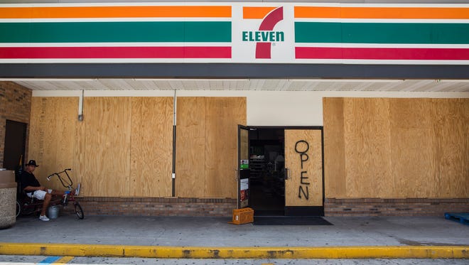 A boarded up 7-Eleven store remained open to customers in Marco Island on Friday, Sept. 8, 2017 before the arrival of Hurricane Irma.