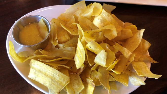Mariquitas, thinly-sliced plantains, fried until “golden and crunchy” and served with garlic sauce for dipping, at Fernandez the Bull.
