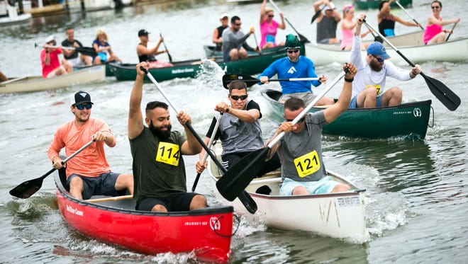 Paddlers battle to pull ahead from the starting line in the 'Ambitious Amateurs' race during the 42nd Annual Great Dock Canoe Race on Saturday, May 12, 2018 at Crayton Cove. The theme for the race this year was 'Reel or FantaSea'.
