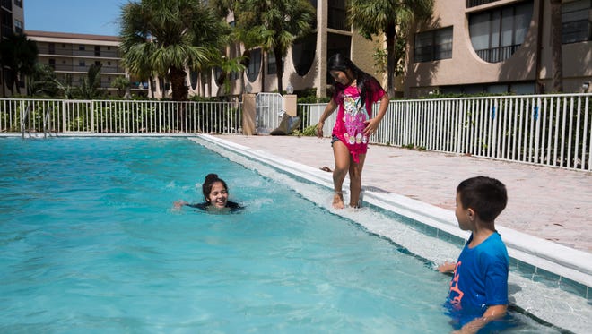 Johanna Leon swims along with her cousin Astrid Santos by her side as her brother Jonathan Leon, 7, looks on at the pool at Angler's Cover Condominiums Marco Island, Fla. Monday, September 11, 2017.
