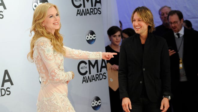 Nicole Kidman, left, and hubby Keith Urban arrive at the 48th annual CMA Awards at the Bridgestone Arena on Nov. 5, 2014, in Nashville.
