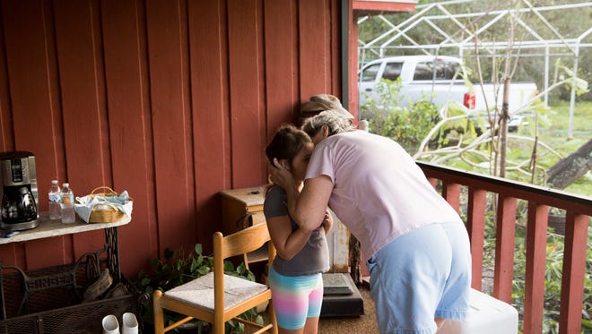 Judy Alander kisses her granddaughter Mia Amell on her front porch along Amity Road after assessing damage from Hurricane Irma Monday, September 11, 2017 in East Naples, Fla. Alander's home was built in the early 1980's and had no structural damage after the storm. "It didn't shake or move it was really solid," Alander said. "We always knew we were blessed and now we know it even more."