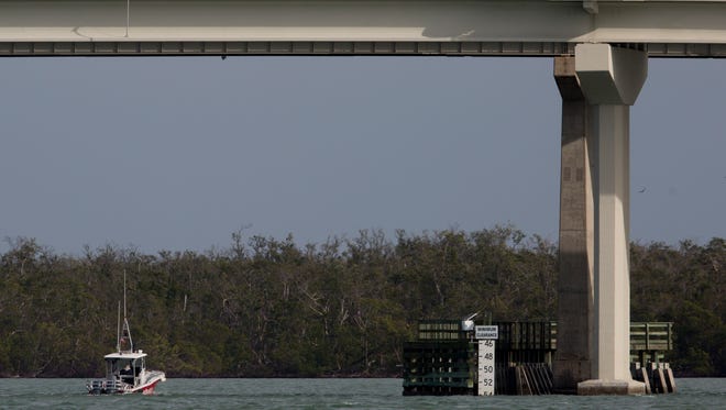 A tow boat passes under the S.S. Jolley Bridge as it shows a minimum clearance of around 55 feet Wednesday, Jan. 17, 2018, in Marco Island, Fla.