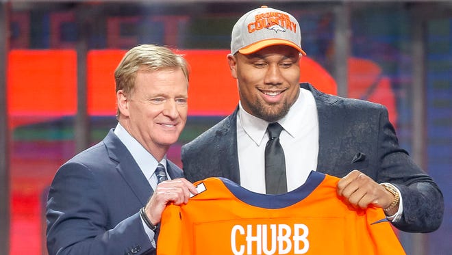 Bradley Chubb (North Carolina State) poses with NFL Commissioner Roger Goodell after being selected as the number five overall pick to the Denver Broncos in the first round of the 2018 NFL Draft at AT&T Stadium.