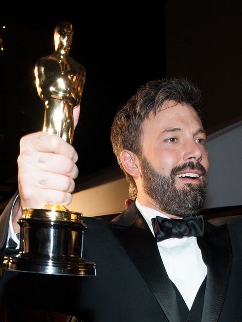 Affleck arrives at the Governors Ball clutching his best picture award from the Oscars for " Argo " on Feb. 24, 2013.