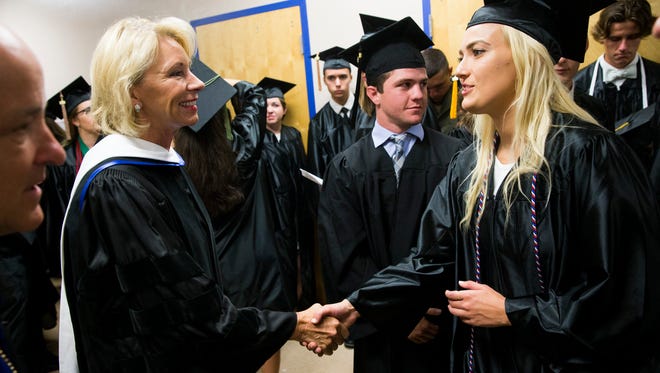 U.S. Secretary of Education Betsy DeVos greets soon to be Ave Maria University graduates prior to delivering her commencement address during Ave Maria's graduation ceremony at Golisano Field House Saturday, May 5, 2018 in Ave Maria.
