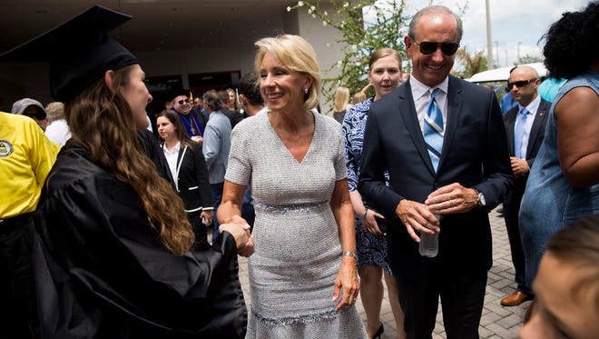 U.S. Secretary of Education Betsy DeVos greets Ave Maria University graduates after graduation outside Golisano Field House Saturday, May 5, 2018 in Ave Maria. DeVos gave the commencement address during the graduation ceremony.
