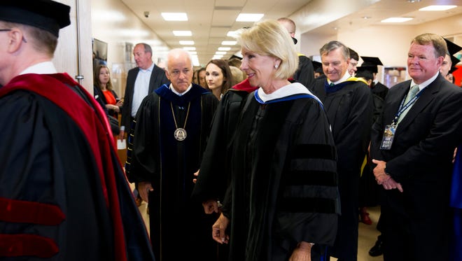 U.S. Secretary of Education Betsy DeVos enters the assembly hall prior to delivering her commencement address for Ave Maria's 2018 graduation ceremony at Golisano Field House Saturday, May 5, 2018 in Ave Maria.