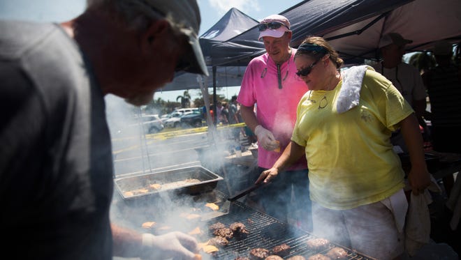 Laura Owen, general manager at CJ's, mans the grill at Kretch's on Tuesday, September 12, 2017, two days after Hurricane Irma. Kretch's and CJ's teamed up to fire up the grills to feed hot meals for free to those without power.