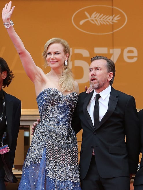 Nicole Kidman and Tim Roth pose as they arrive for the opening ceremony and the screening of their film " Grace of Monaco " at the 67th edition of the Cannes Film Festival.
