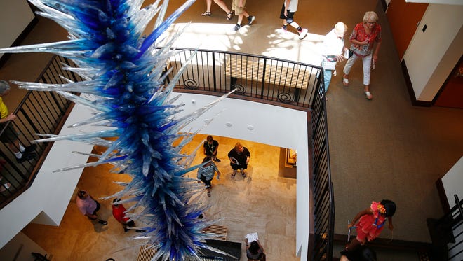 Patrons wander through the Baker Museum and past the large Dale Chihuly Blue Icicle glass sculpture at Artis–Naples in Naples in May 2016. That and other sculptures have been put in storage for the museum's remodel.