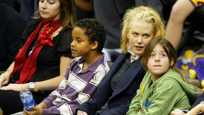 Nicole Kidman and her children she shares with Tom Cruise, Connor and Isabella, attend a game between the Los Angeles Lakers and the Miami Heat at the Staples Center on Dec. 25, 2004.