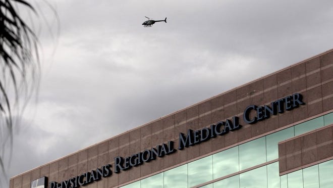 A helicopter flies over Physicians Regional Hospital on Pine Ridge Road in East Naples. File