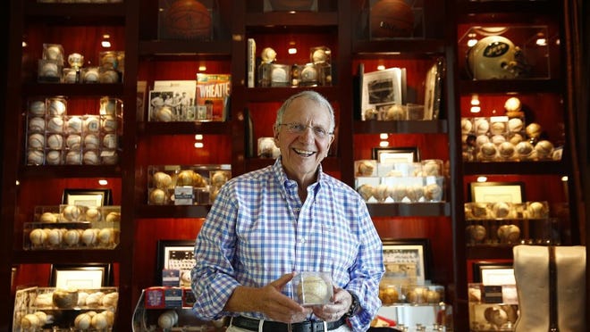 Jay Baker, retired president of Kohl's department store, is shown in portrait with his collection of sports signatures on balls, pictures and equipment Tuesday, April 26, 2016 at his penthouse home in Naples, Fla. Baker is an avid seeker of Yankees memorabilia. He is perhaps Naples' most prominent philanthropist-giving millions to create an art museum, playhouse and park, among other gifts. (Corey Perrine/Staff)