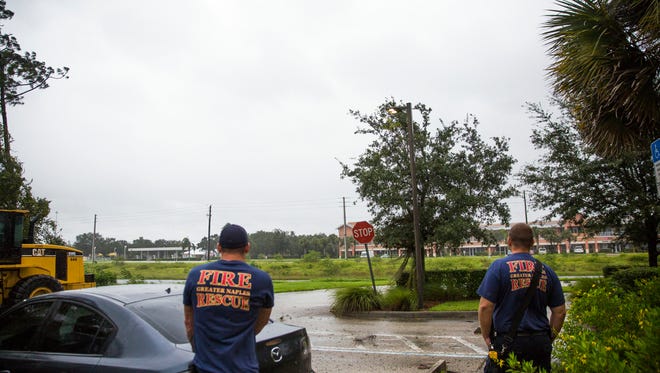 Paul Pernak, left, and Captain Jason Sellers stand outside of the Greater Naples Fire Rescue Station 72 and watch as the wind picks up on Sunday, September 10, 2017.