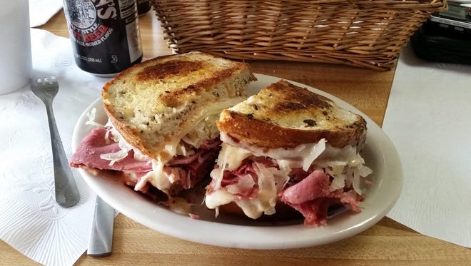 Rita's Ruben Ritual, a corned beef sandwich on rye bread with sauerkraut, Swiss cheese and Russian dressing, sits on a table at Larry's Lunch Box waiting to be eaten.