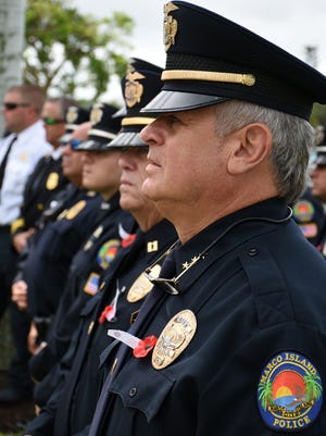 Police Chief Al Schettino stands in the ranks of his officers during a Memorial Day observance at Veterans' Community Park/