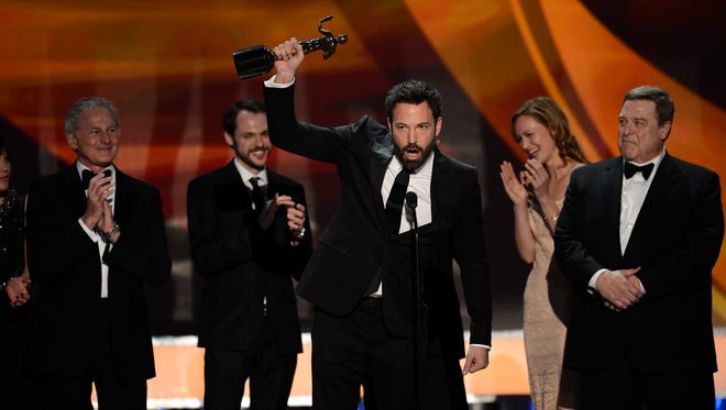 The cast of " Argo " looks on as Affleck raises the award for outstanding cast, the equivalent of best picture, at the Screen Actors Guild Awards in 2013.
