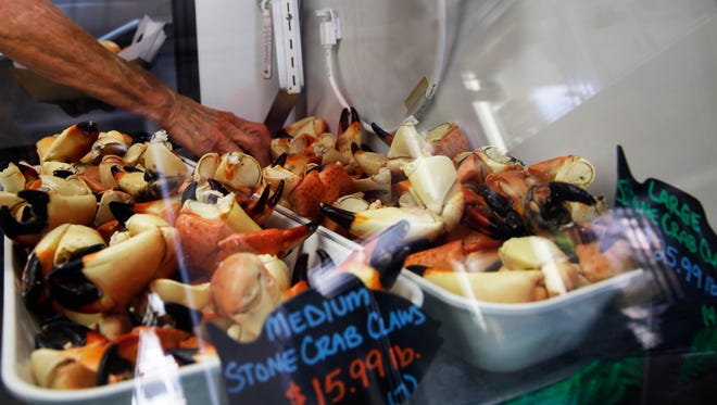 Patty Kirk prepares an order of stone crab on the first day of stone crab seaon at Kirk Fish Company in Goodland on Sunday, Oct. 15, 2017.