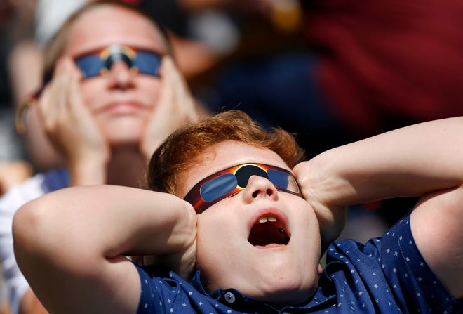 Joelston Miller, foreground, and Jordan Oakley, both fourth graders, react to seeing the moon pass in front of the sun. The entire student body, faculty and some parents gathered in a field on the north side of James Griffith Intermediate School to view the solar eclipse Monday afternoon, Aug. 21, 2017. Special glasses with very dark lenses were purchased to allow teachers and students to safely view the celestial event. Children were served Moon Pies as a snack to enjoy while viewing the eclipse. Photo by Jim Beckel, The Oklahoman