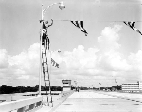 Old Fuller Warren Bridge (June 7, 1954): Opening of Fuller Warren (Gilmore Street) Bridge. State archives note: " Man is raising flags for opening of the bridge. "