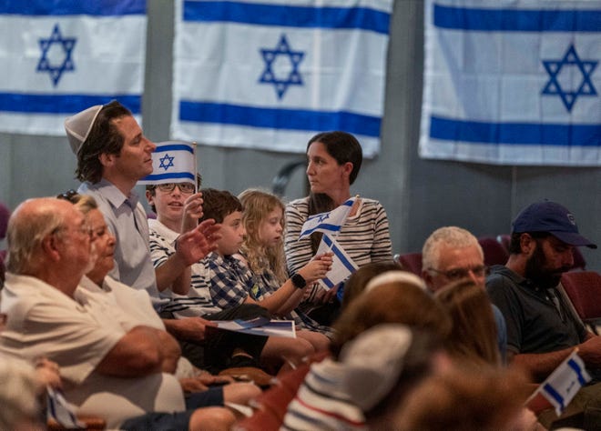 A family shows their solidarity for Israel at an event at Congregation B'Nai Israel in Boca Raton, Florida on October 10, 2023.
