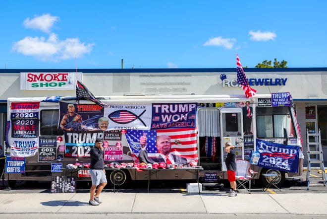 Flags and hats for Trump supporters are up for sale before former President Donald Trump is scheduled to speak at Ted Hendricks Stadium at Henry Milander Park in Hialeah, Florida, Wednesday, November 8, 2023.