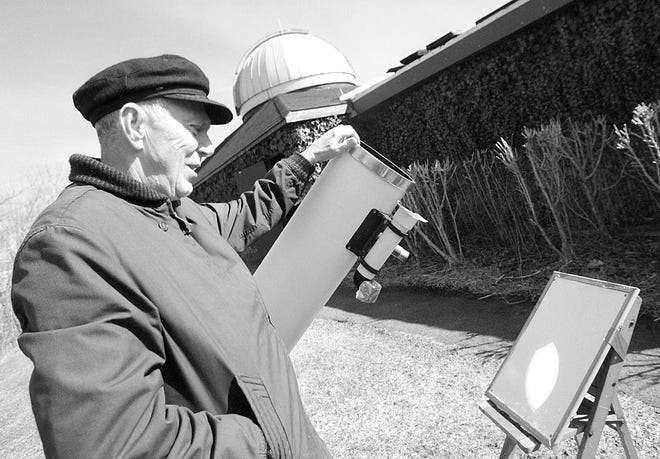 Art Koch, a volunteer at The John J. Crowley Nature Center at Rifle Camp Park in W. Paterson, views a projection of the partial eclipse of the sun. He is useing an 8 inch telescope.