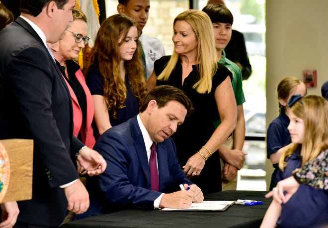 Florida Governor Ron DeSantis signs the paperwork for Florida House Bill 3. Governor DeSantis was at the Cornerstone Classical Academy in Jacksonville, FL Monday, March 25, 2024, along with local and state leaders to sign into law Florida House Bill 3 which bans Floridians younger than 16 from "addictive" social media platforms but with exceptions for those who are 14 or 15 and get parental permission.