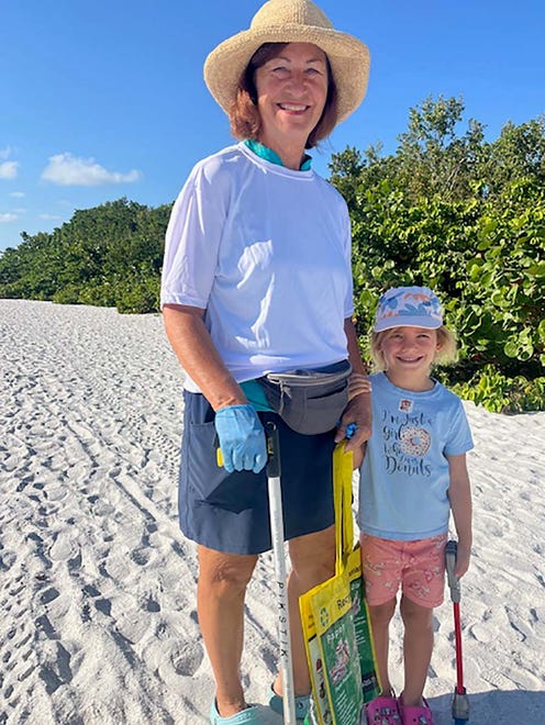 Marci Kinter and granddaughter Ellie cleaningup the beach.