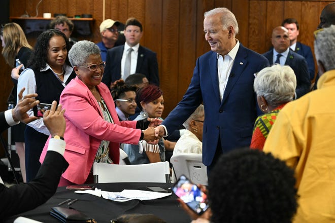 US President Joe Biden greets a supporter as he meets with campaign volunteers at Dr. John Bryant Community Center in Racine, Wisconsin, on May 8, 2024.