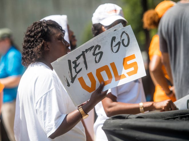 Fans use signs to fan themselves before the Tennessee Volunteers' game against West Virginia in the Belk College Kickoff at Bank of America Stadium in Charlotte, N.C., on Saturday, Sept. 1, 2018.