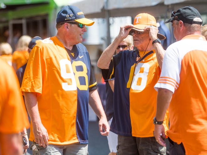 Lee Kelly, left, and Robert Kelly, right, sport jerseys supporting both the Vols and WVU before the Tennessee Volunteers' game against West Virginia in the Belk College Kickoff at Bank of America Stadium in Charlotte, N.C., on Saturday, Sept. 1, 2018.
