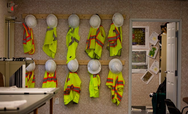Neon vests and hard hats hang at the temporary work space of the Caloosahatchee Reservoir project in Hendry County. The project is also known as C-43 West Basin Storage Reservoir.