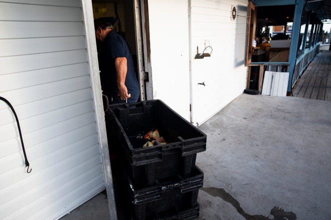 Dock master Bill Winans wheels crates of stone crab claws into the kitchen on the first day of stone crab season on Monday, October 15, 2018, at Kelly's Fish House Dining Room in Naples.