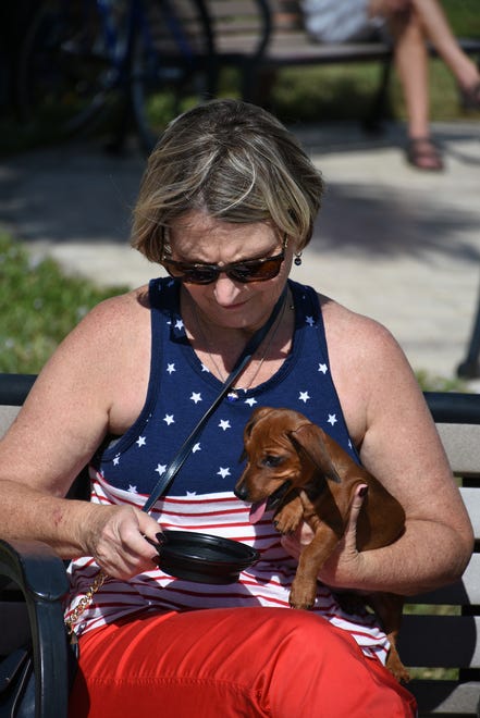 Robin Browning gives water to Ginger, her dachshund. Marco Island honored veterans, in particular female veterans, in Veterans Community Park for Veterans Day, at 11 a.m. Monday, Nov. 12.