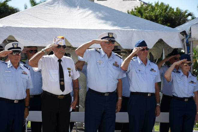 Veterans salute during the Pledge of Allegiance.  Marco Island honored veterans, in particular female veterans, in Veterans Community Park for Veterans Day, at 11 a.m. Monday, Nov. 12.