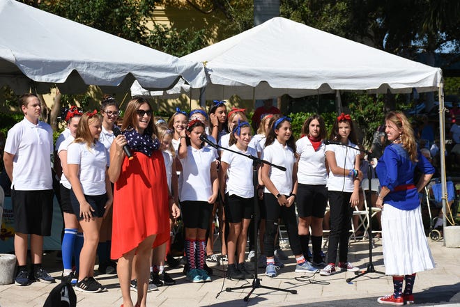 Sarah Hadeka and local schoolchildren, led by Martha Miller, sing "God Bless the USA." Marco Island honored veterans, in particular female veterans, in Veterans Community Park for Veterans Day, at 11 a.m. Monday, Nov. 12.