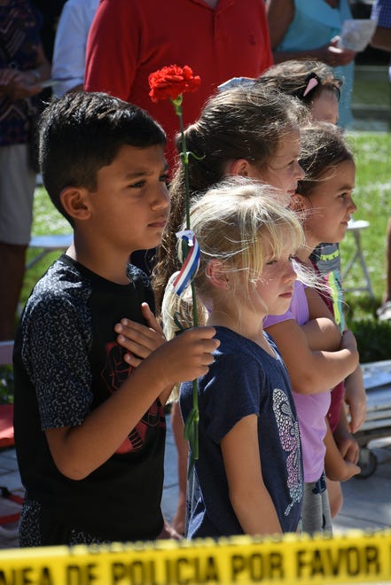 Kids including Kazim Kasap, 7, stand for the Pledge of Allegiance. Marco Island honored veterans, in particular female veterans, in Veterans Community Park for Veterans Day, at 11 a.m. Monday, Nov. 12.