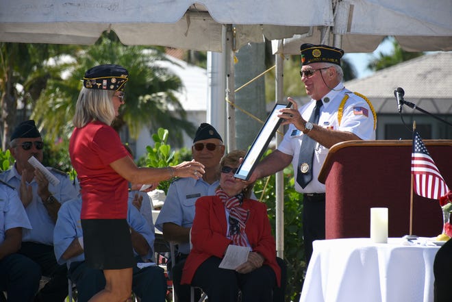 Lee Rubenstein presents a framed proclamation to Army and Navy veteran Lee Ross, left. Marco Island honored veterans, in particular female veterans, in Veterans Community Park for Veterans Day, at 11 a.m. Monday, Nov. 12.